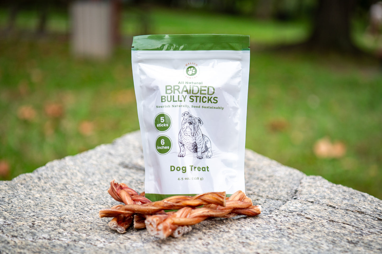 Bag of Braided Bully Sticks dog treat on a rock with a blurred natural background