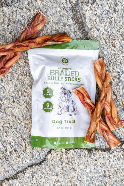 Package of All Natural Braided Bully Sticks dog treat with five sticks on a concrete surface